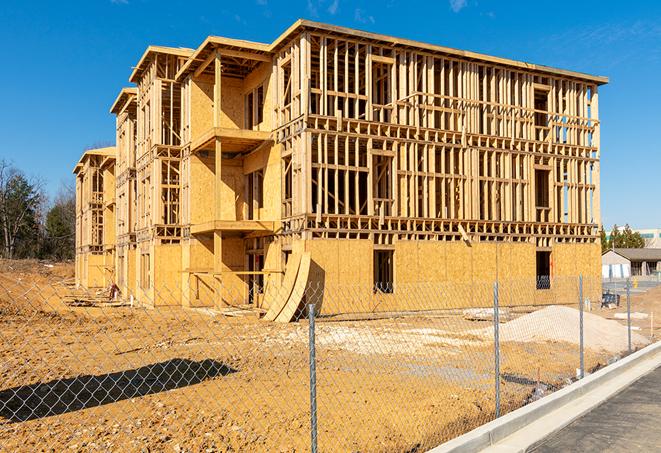 a temporary chain link fence in front of a building under construction, ensuring public safety in Hampton, VA